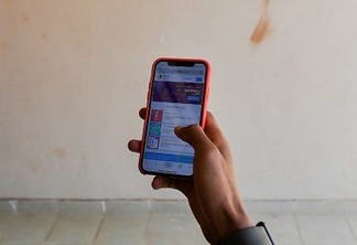 Kago Kagichiri, the creator online tutorial platform called Eneza education, shows the application on his phone in Riruta suburb, in the Kenyan capital Nairobi on November 8, 2018. - The platform aims to offer the education for especially rural area in Africa through SMS or internet for 10 Kenya Shilling (0.086 euro) per week. About five million learners are registered in Kenya, Ghana and Ivory Coast. (Photo by TONY KARUMBA / AFP)