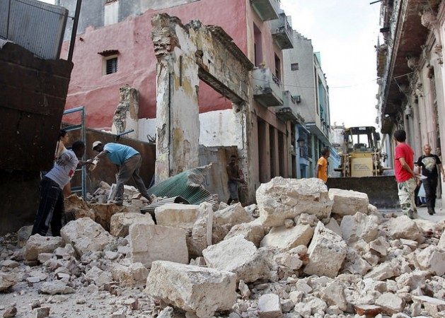 Dois homens recuperam tijolos de um prédio derrubado para utilizá-los na construção de casas, em Havana Velha, em Cuba. Foto: Jorge Luis Baños/IPS