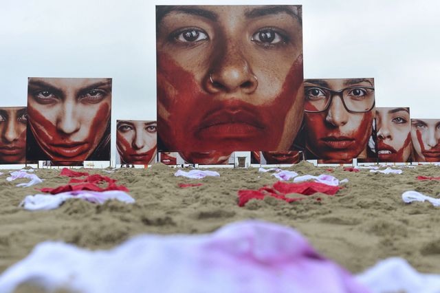 A organização Rio Paz encheu as areias de Copacabana de roupa íntima feminina da cor de sangue ou ensanguentada e de megafotografias de mulheres com o rosto também ensanguentado, representando a população feminina assassinada no Brasil. Foto: Tânia Rêgo/Agência Brasil