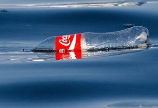 Paracas, Peru - January 20, 2015: Human pollution in the Pacific Ocean currents. An empty plastic coke bottle floats on the surface