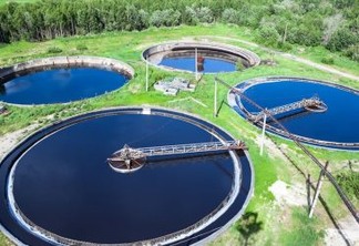 Primary sedimentation stage, sewage flowing through large circular tanks with mechanically driven scrapers